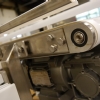 Adjustable side rails on a stainless steel flat belt conveyor